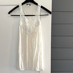 Cream Crochet racer back sheer tank top with elastic bottom edge.